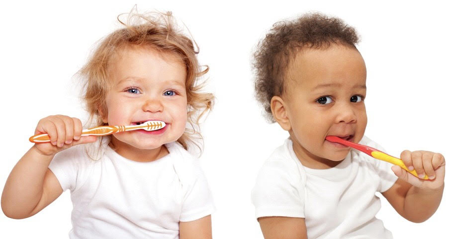 Two babies brushing teeth
